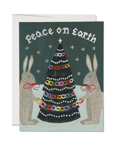 Greeting card with two rabbits holding a decorated Christmas tree and &